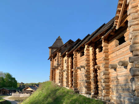 Wooden fortress wall against the sky. Medieval fortress with high walls. Wooden installation in the style of an ancient city. Park "Kievan Rus" Kiev region, Obukhov district, village Kopachevo, May 10, 2021.のeditorial素材