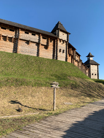 Wooden fortress wall against the sky. Medieval fortress with high walls. Wooden installation in the...
