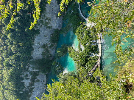 The beautiful Plitvice Lakes in Croatia boast clear turquoise waters and majestic waterfalls framed by lush green mountains, creating a picturesque summer retreat for adventurers and nature lovers.の写真素材