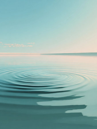 Ripples spreading across a calm body of water with a serene horizon viewed on a sunny dayの素材