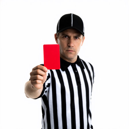 Referee displays a red card to signal a foul during a sports match, highlighting an important decision at a crucial moment in the gameの素材