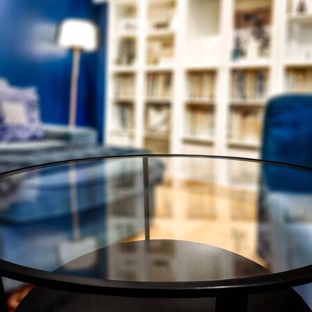 Glass table top with a blurred home interior background. Empty space background for you products and...