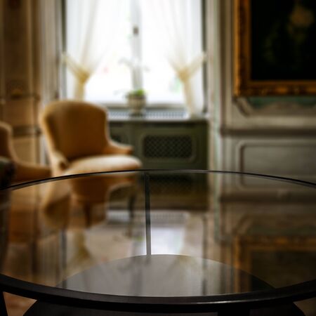 Glass table top with a blurred home interior background. Empty space background for you products and...