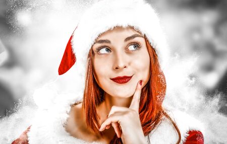 Santa Claus woman with snowy winter background.