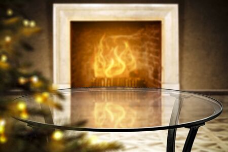 Glass table top with a blurred fireplace background. Empty space for your products and decoration.の写真素材