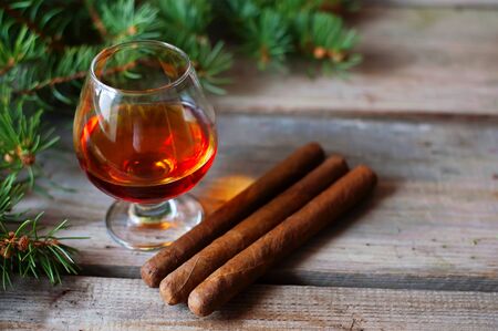 quality cigars and cognac on an old wooden tableの写真素材
