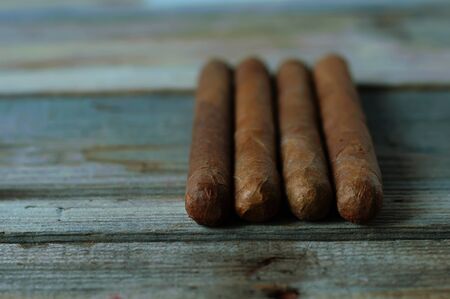 quality cigars on an old wooden table