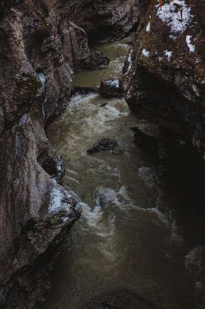 mountain river and snow the river in a mountain gorge, after a snowfallの写真素材