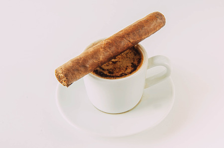 Cup and Turk coffee, cigar and guillotine isolated on white background. Toning. copy space.の写真素材