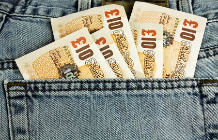 Ten pound notes sticking out of a back pocketの写真素材