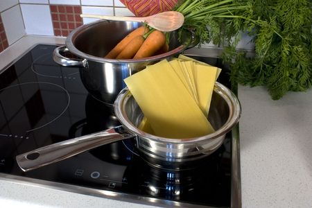 Cooking in the kitchen - boiling in stainless steel potsの写真素材