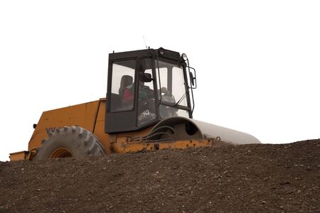 Road roller working on brown soil - white isolated
