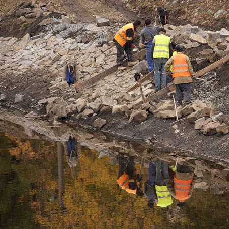 Group of men working at the riverbank