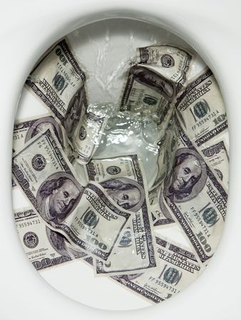 Flushing dollar bills into a toilet bowlの写真素材