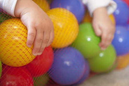 Child playing on carpet with toy blocksの写真素材