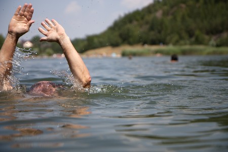 Drowning swimmer at a lake in summerの写真素材