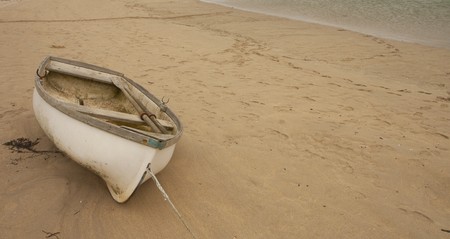 Boat lying on a sandy beachの写真素材