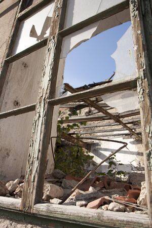 Ruined house - broken window and ceiling