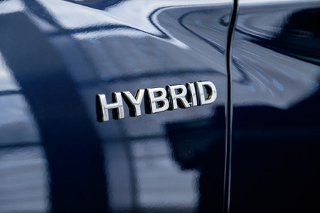 A close-up photograph of the inscription Hybrid on the autobile of black color. Hybrid engine.の写真素材