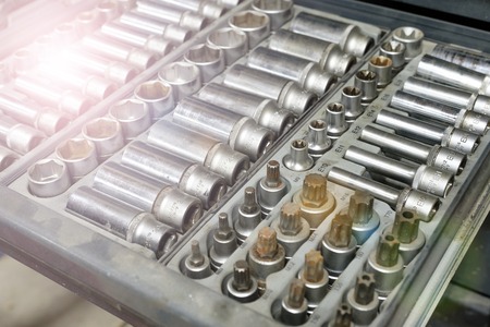 Set of tools closeup - wrench heads, nozzles the screwdriver in case. Professional instrument. Selective focusの写真素材