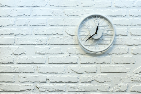 Clock in white brick wall. Background