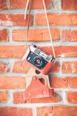 RUSSIA, MOSCOW - September 02, 2019: Vintage analog film camera with lens on a brick wall backgroundのeditorial素材