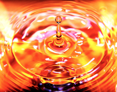 Macro shot of a water drop collision. Abstract background for design.の写真素材