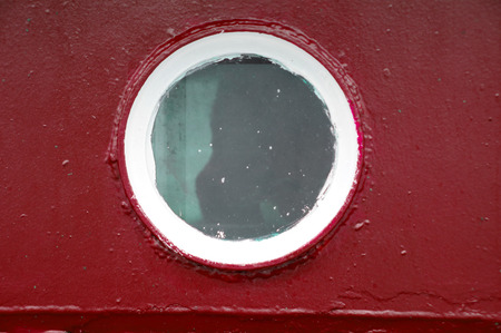 The old ship porthole on dark blue backgroundの写真素材