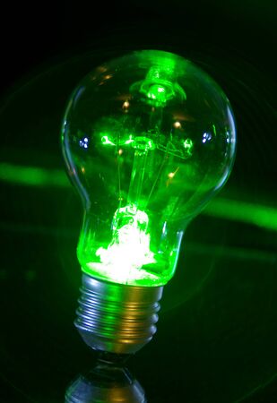 Concept of classic bulb green power light with laser rays.の写真素材