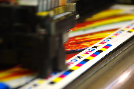 Printing head creates CMYK test and image on paper. Colorful large plotter printer machine.の写真素材
