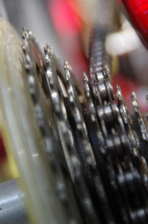 Bicycle derailleur in close-up view. Bike chain and gear details.