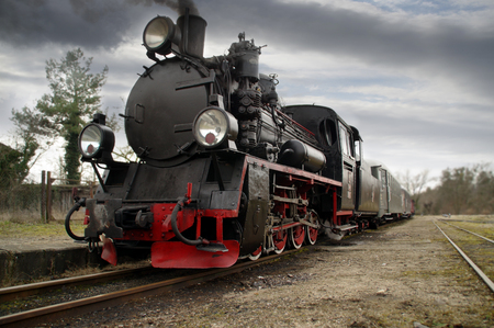 Retro steam engine locomotive on the tracks. Historic train.の写真素材