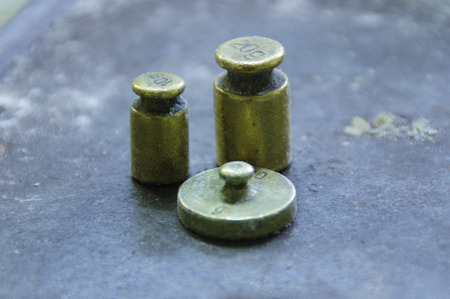 A set of old used vintage weights. Measurements of grams and kilograms of steel and copper. Retro...