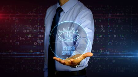Man with dynamic cyber eye symbol hologram on hand. Businessman showing futuristic concept of digital surveillance, spying, hacking and violation of privacy with light circle.の写真素材