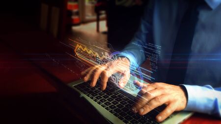 Man typing on laptop with cyber safety with key symbol hologram screen over keyboard. Concept of computer security, encryption and password protection with light and glitch effect.の写真素材
