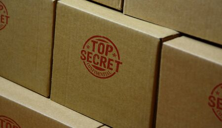 Top secret confidential stamp printed on cardboard box. Government, business, legal and non public document  concept.の写真素材