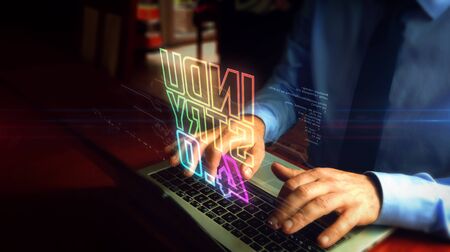 Man typing on laptop with industry 4.0 hologram screen over keyboard. Concept of innovation, cyber...