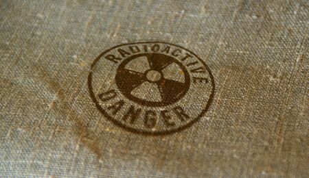 Radioactive danger symbol stamp printed on linen sack. Atomic energy warning, radiation alert and nuclear power hazard concept.の写真素材