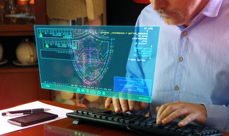 Man typing computer keyboard with futuristic hologram screen. Abstract concept of cyber security,...