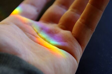 Light spectrum on the palm of handの写真素材