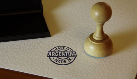 Made in Argentina stamp and stamping hand. Factory, manufacturing and production country concept.の写真素材