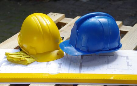 Yellow and blue protective helmet. Personal protective equipment. Safety at the construction site.の写真素材