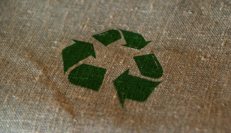Recycling stamp printed on linen sack. Recycle symbol, arrows, recyclable materials, environmental protection and earth safe concept.の写真素材