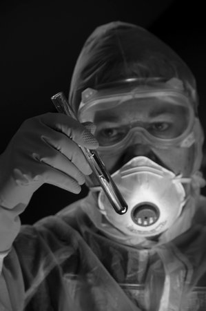 A scientist with a test tube in his hand is working on a new substance. Concept of pharmacy, research, biochemistry, microbiology, medicine, science, vaccine and biotechnology experiment.の写真素材