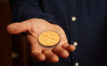Holochain Holo HOT cryptocurrency symbol golden coin in hand abstract concept.の写真素材