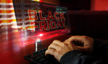 Black Friday on computer screen. Big sale, hot deal, shopping and special offer abstract concept 3d with glitch effect. Man typing keyboard.の写真素材