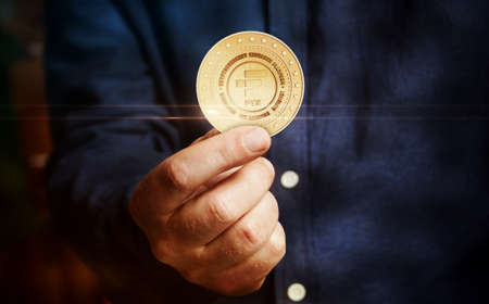FTX NFT Bahamas, peer to peer, cryptocurrency platform symbol golden coin in hand abstract concept.の写真素材