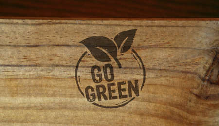 Go green and eco friendly symbol stamp printed on wooden box. Co2 neutral, ecology, environment, nature and climate concept.の写真素材