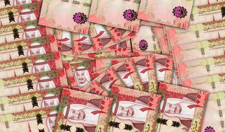 Saudi Arabia Riyal banknotes in a cash fan mosaic pattern. 100 SAR notes. Abstract concept of bank,...
