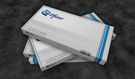 Poznan, Poland, October 2, 2023: Pfizer tablets box production line. Pharmaceutical company. Pills...